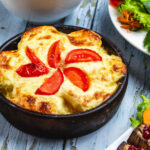 side view casserole with potato cheese tomato clay dish 141793 4802 1