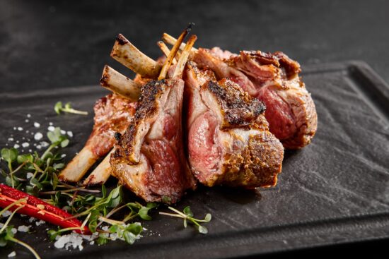 Rack of lamb in Brooklyn NY served with Yaffa NYC’s signature Mediterranean sides